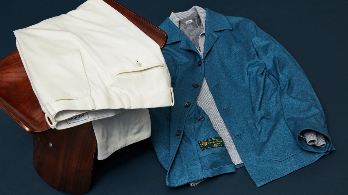 White trousers and a blue overshirt laid flat