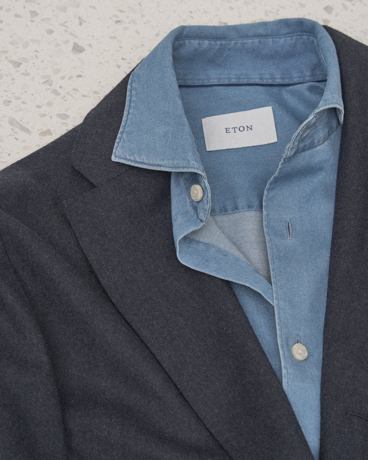 Man wearing an Eton shirt and tie with a suit