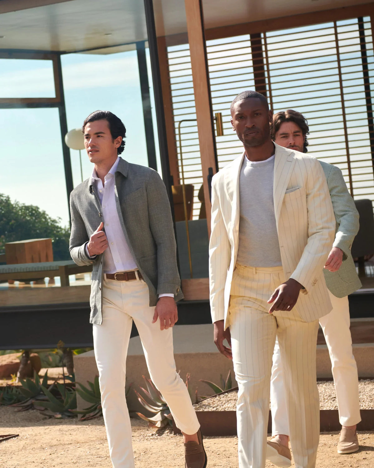 Men in cream and sage tailoring walking in desert sun