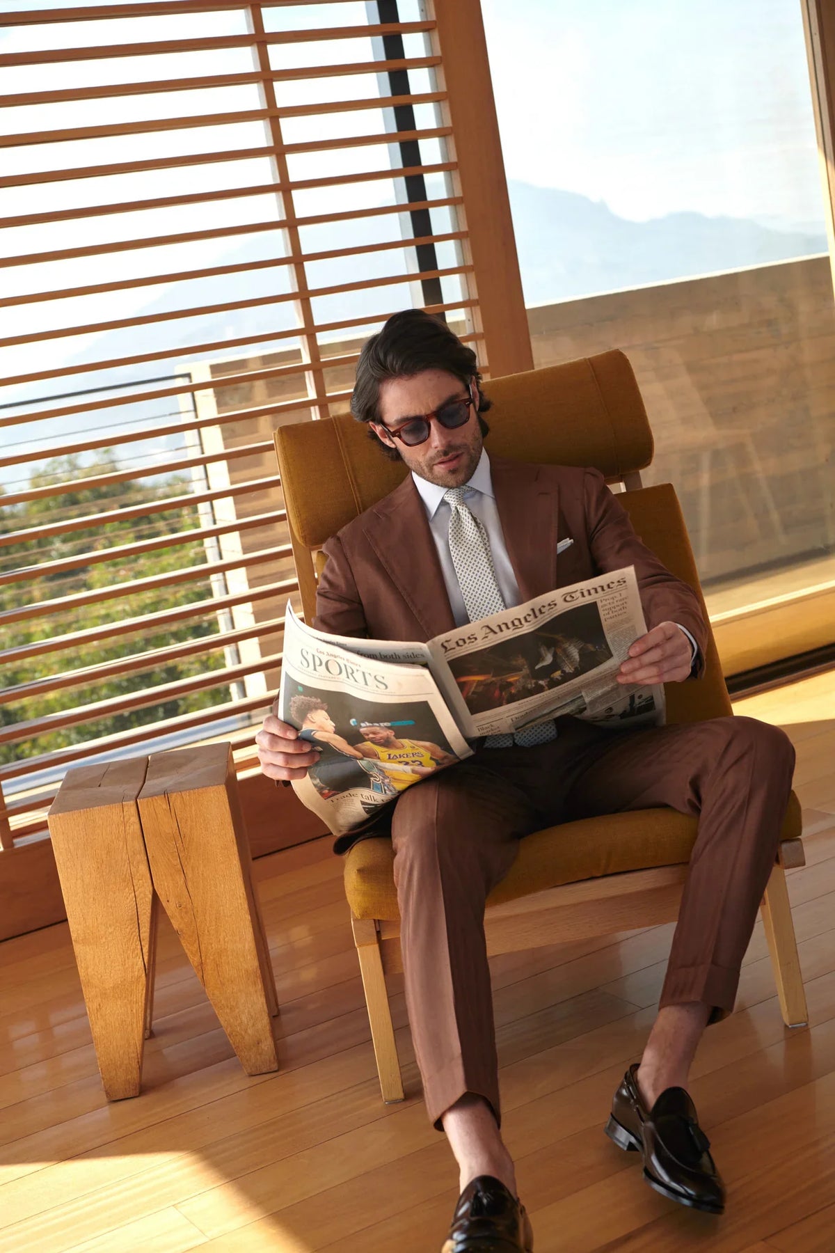 Man sitting on a chair waiting for a made to measure appointment for a custom suit