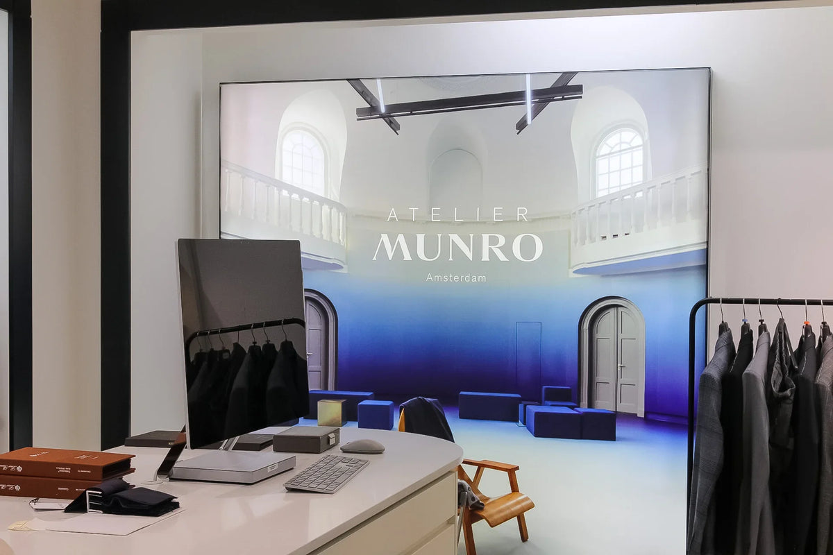A workstation with a computer and notebook, ready for a style consultation session with a client.