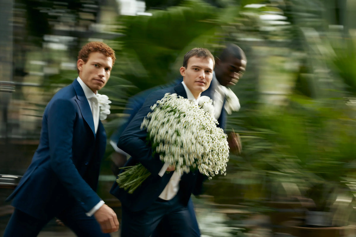 Groom and groomsmen running to the aisle