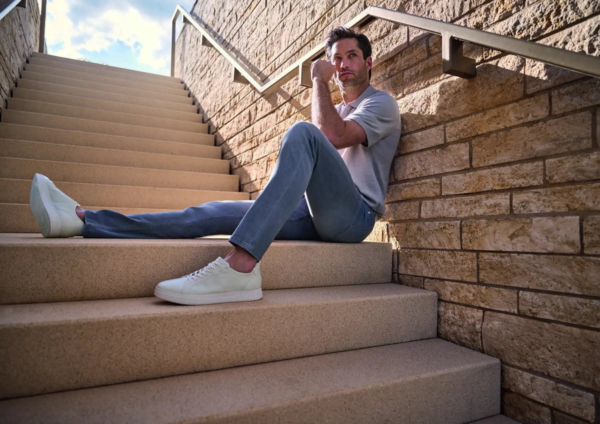 Alberto 5 pocket pants man laying down on stairs