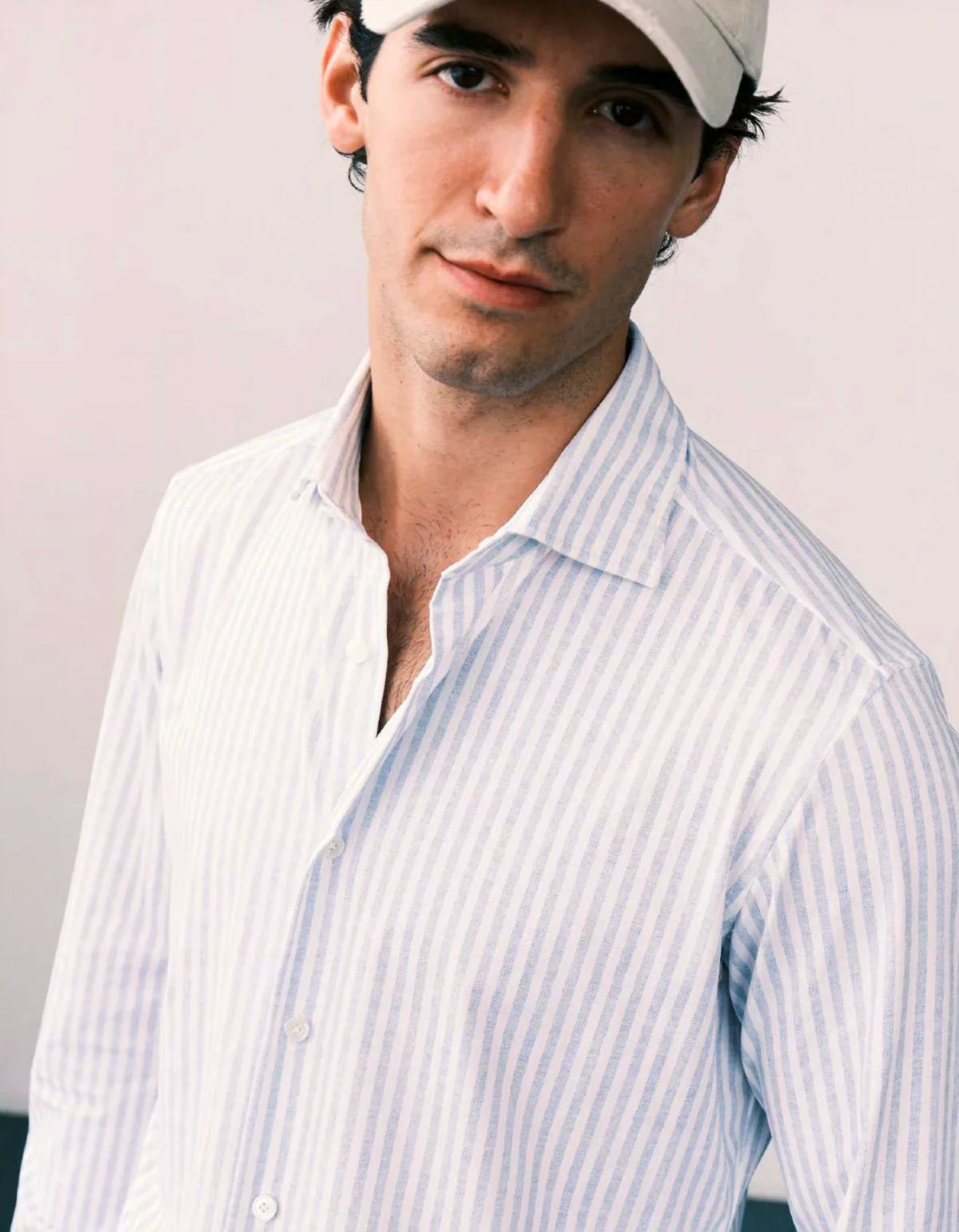 Man in cap and white striped shirt