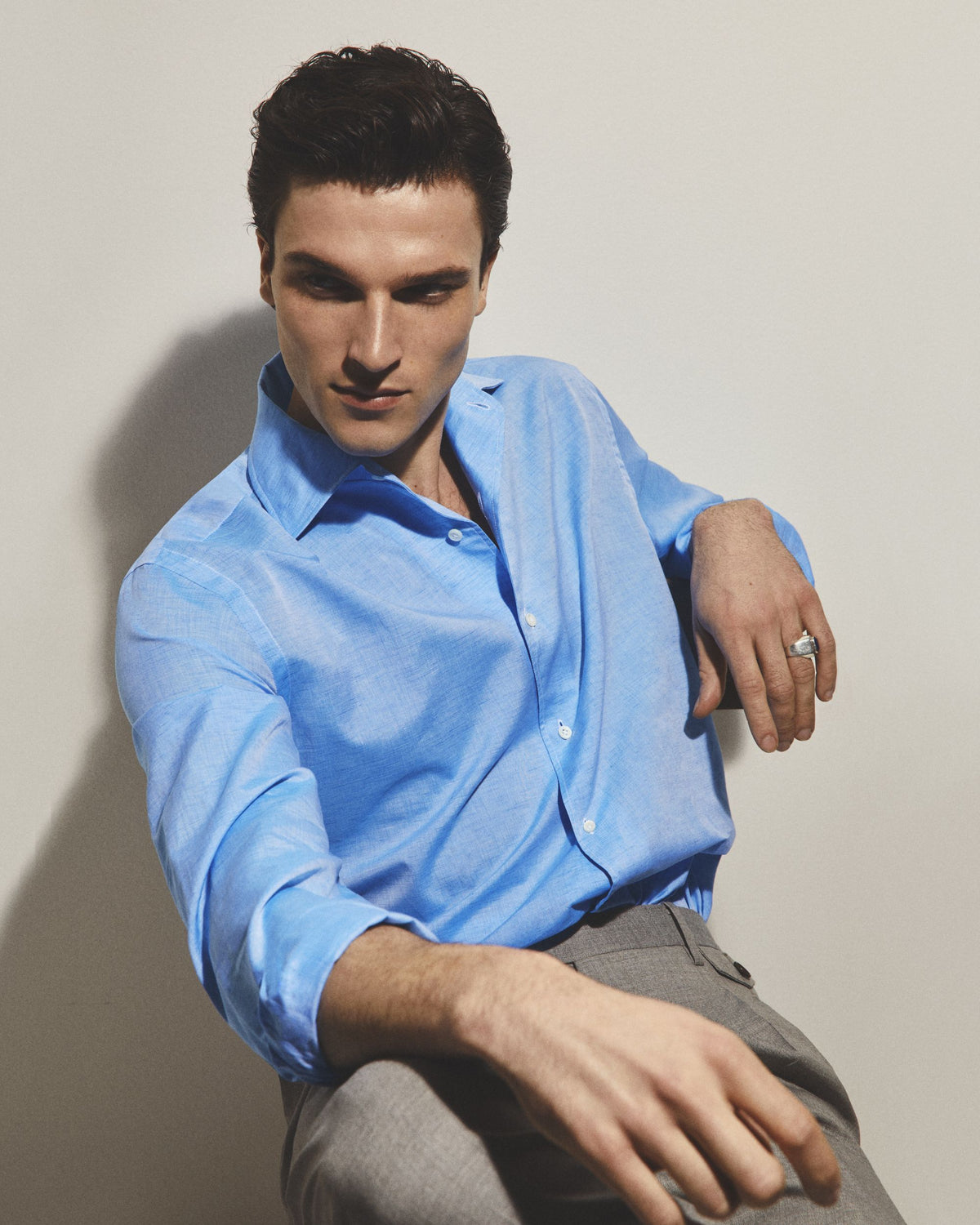 Man wearing blue shirt sitting in a chair