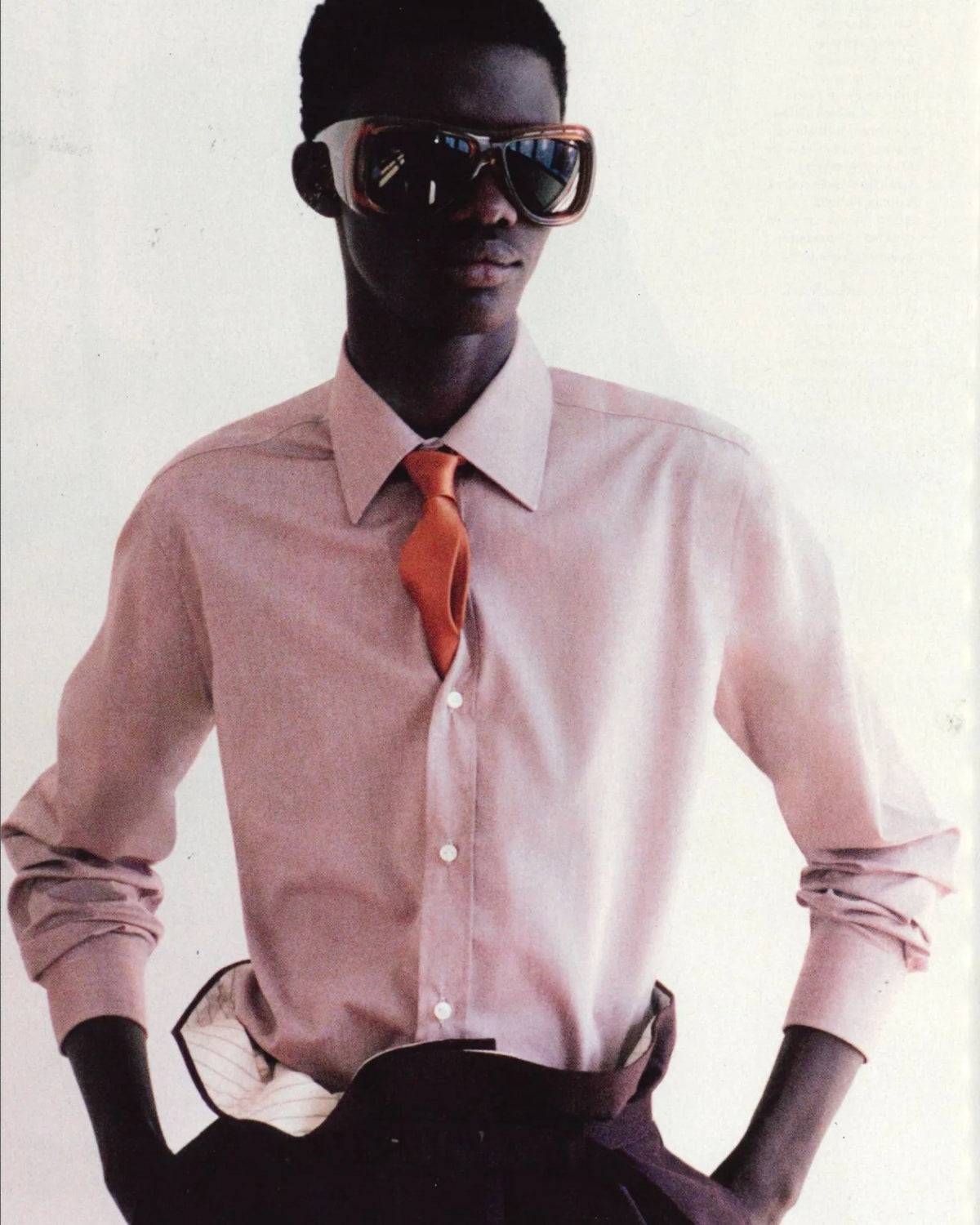 Man in a pink Barba Napoli dress shirt with an orange tie.