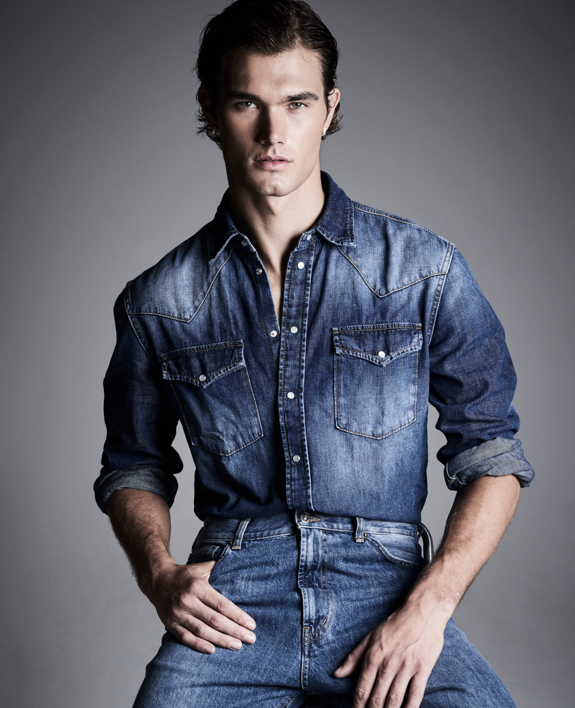 man sitting in dondup jeans