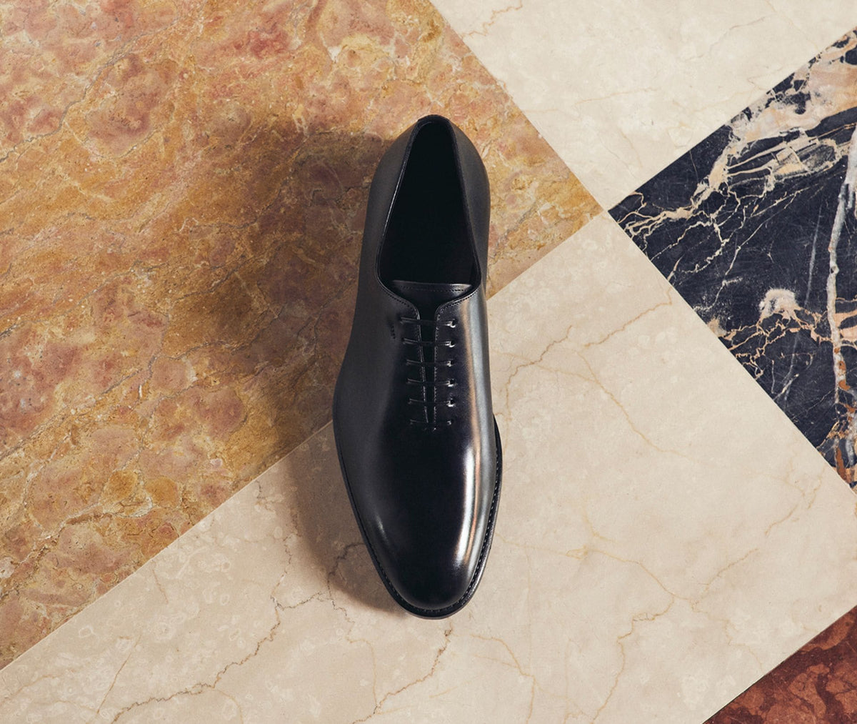 Ferragamo black leather oxford on marble