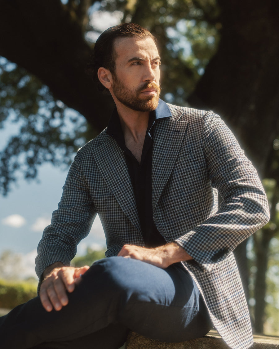 Galliani houndstooth sport coat with a navy polo and blue trousers