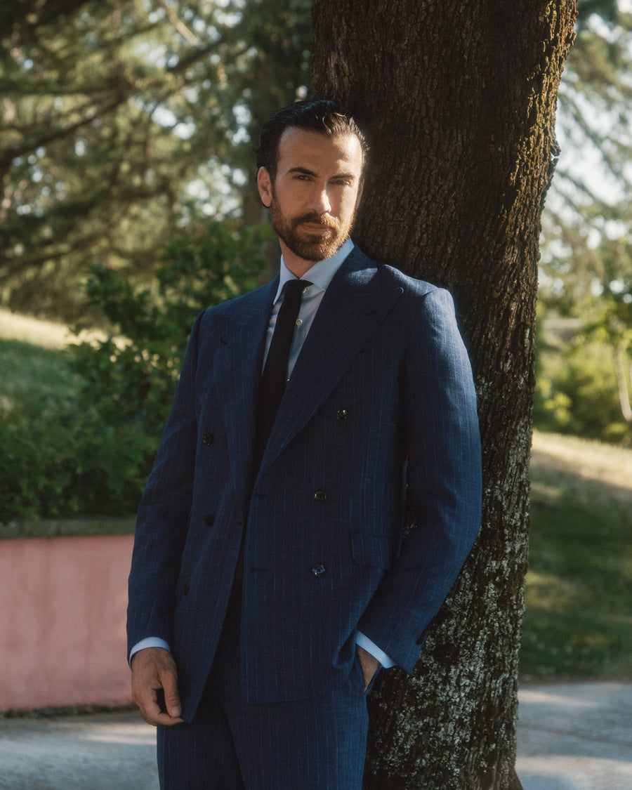 Galliani navy pinstripe double-breasted suit, portrait by a tree