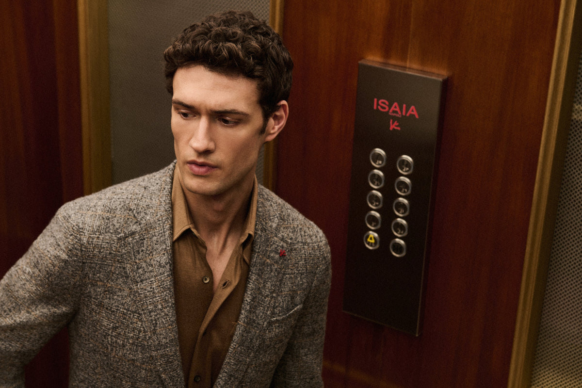 Man in Isaia jacket in an elevator