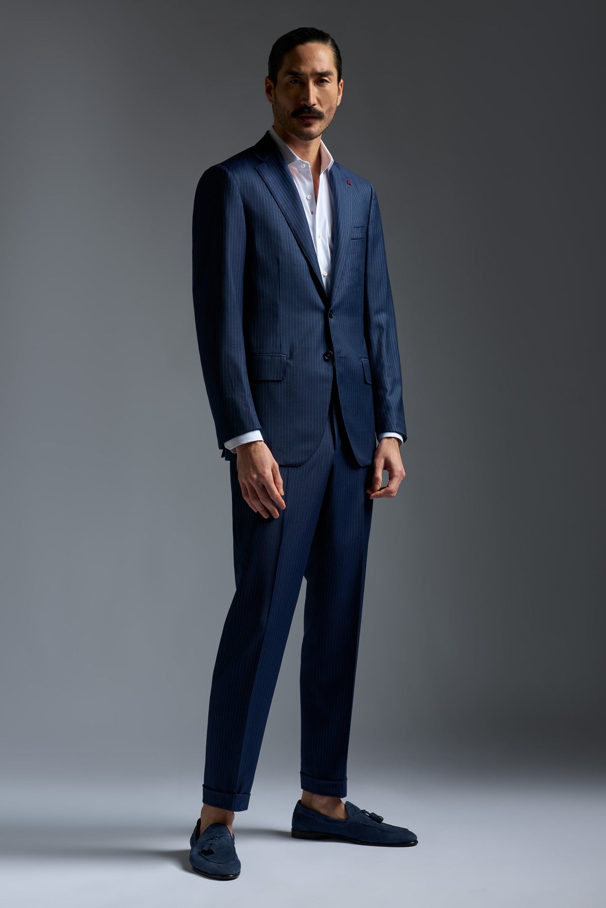 Man in Isaia suit with signature red coral on the lapel