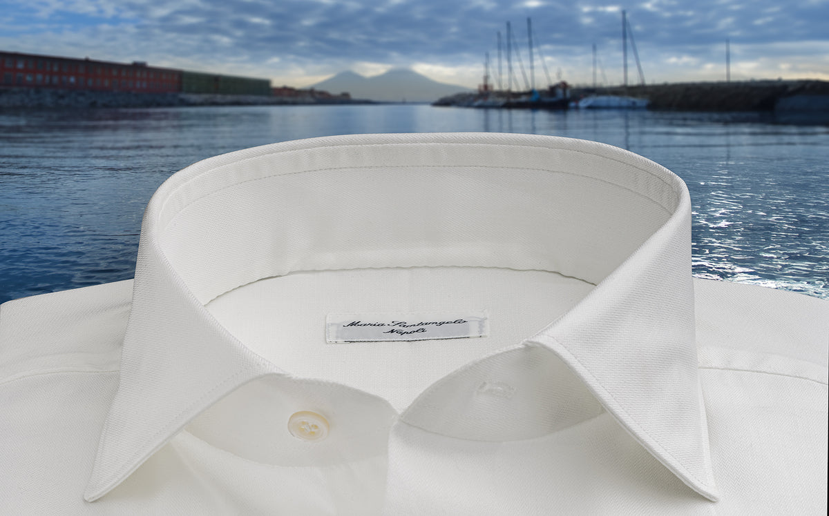 Maria Santangelo white shirt collar against a harbor view