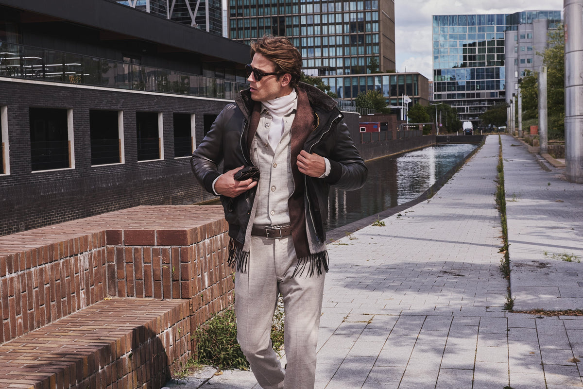 Moorer model in leather outerwear walking in a city