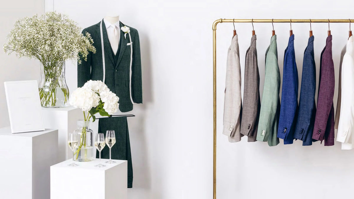 Green wedding suit display beside a rail of jackets