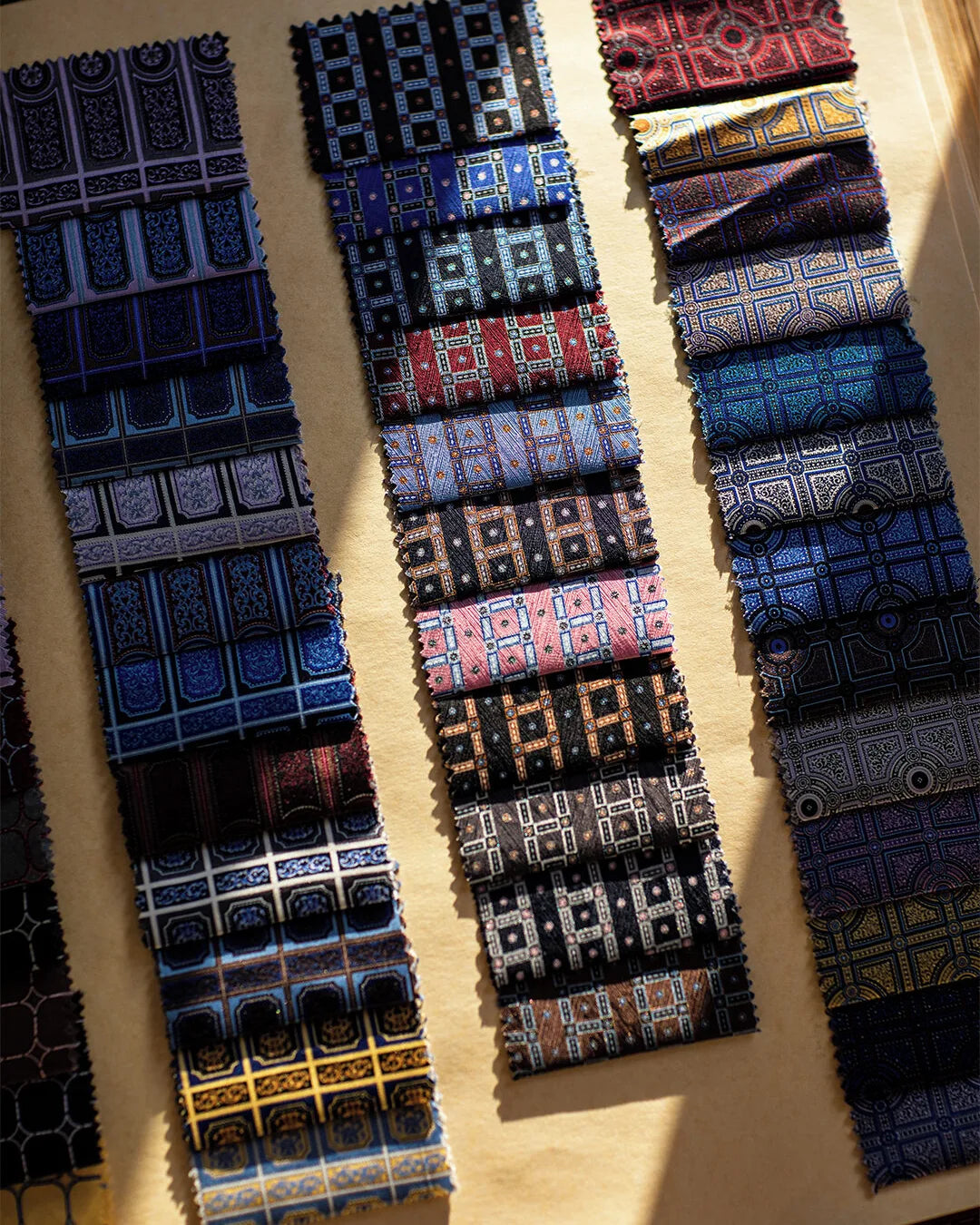 Rows of Stefano Ricci silk tie fabrics in blue, navy and burgundy patterns.