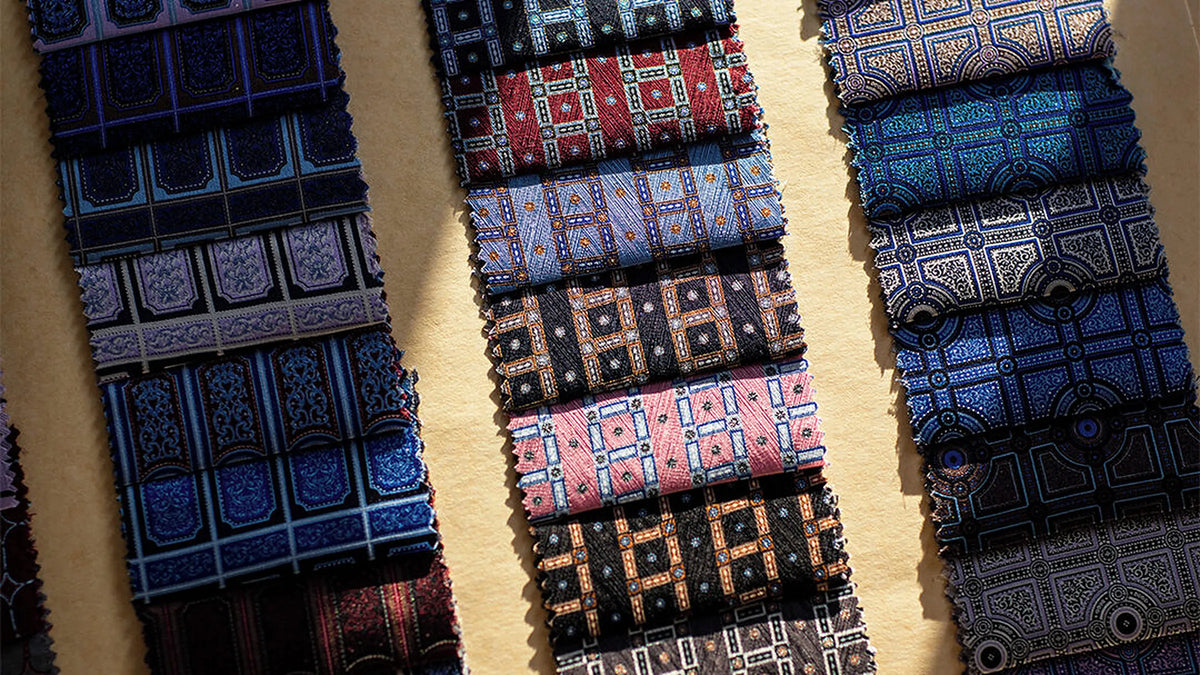 Rows of Stefano Ricci silk tie fabrics in blue, navy and burgundy patterns.